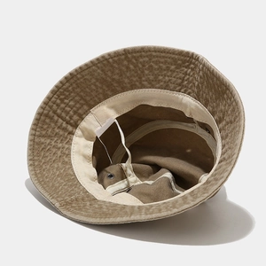 Inside view of khaki washed canvas bucket hat featuring sweatband and metal eyelets