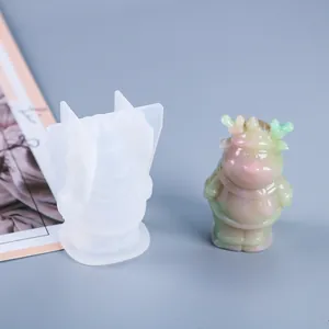 DIY Christmas reindeer silicone mold and colorful resin figurine on a blue background