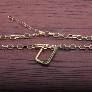 Gold hip hop cuban link necklace featuring emerald green zircon studded carabiner pendant