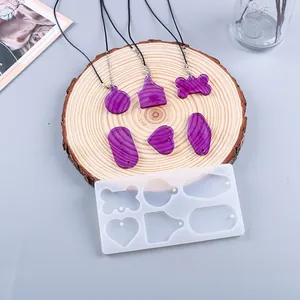 Detail van siliconen mal voor hars met afgewerkte paarse getextureerde hangers