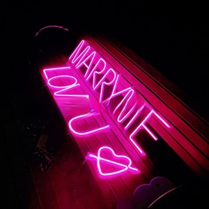 Close-up of pink LED neon signs featuring Marry Me and Love U text for proposal decor