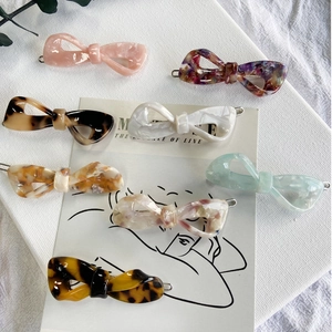Collection of premium acetate hair clips featuring various marble and floral bow designs