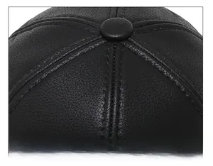 Close-up of black leather baseball cap top showing high-quality stitching and six-panel crown