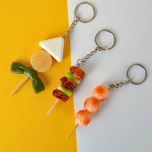 Detail of realistic BBQ skewers and Oden food pendants on keychains with metal rings