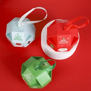 Creative hexagonal Christmas candy gift boxes in red, green and blue with ribbon handles