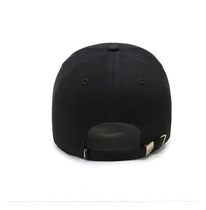 Rear view of black cotton baseball cap showing adjustable bronze metal buckle and fabric tag