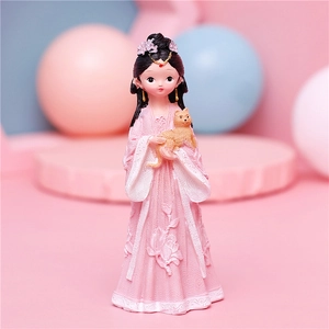 Macro detail of a cute resin girl figure in pink Hanfu holding a golden cat