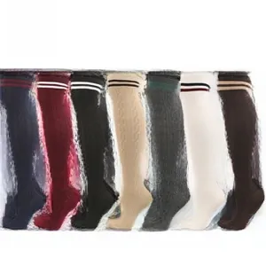 Detail showing various colors of cable knit over-knee socks with striped cuff designs