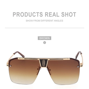 Detail view of large square brown gradient sunglasses with elegant golden metal frame
