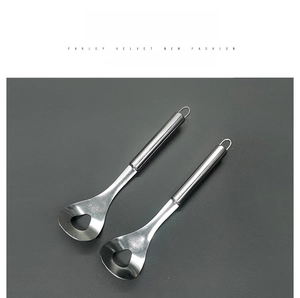 Macro detail of stainless steel meatball scoop with triangular hole and long handle
