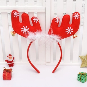 Close-up of red Christmas reindeer headband with white feathers and gold bells