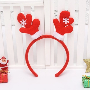 Detailed close-up of a festive red reindeer antler headband with white snowflake patterns