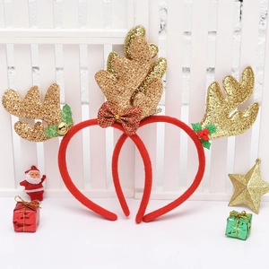 Detail of red Christmas headbands with golden glitter antlers and festive bells