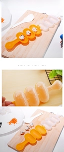 DIY rice ball mold with yellow three-slot design and smiley face patterns for kids