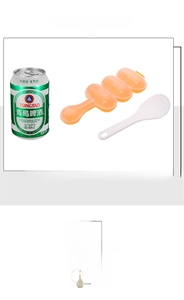 Detail view of orange DIY rice ball shaker mold and matching white plastic rice scoop