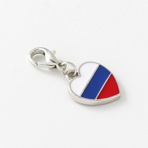 Macro shot of heart-shaped charm with red, blue and white enamel stripes and lobster clasp
