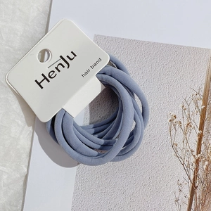 Close-up of blue-grey high-elasticity fabric hair bands on a minimalist card