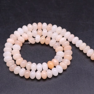 Spiral arrangement of natural abacus stone beads in pink and cream tones for DIY jewelry