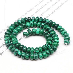 Macro view of green malachite abacus beads for DIY jewelry with dark green textures