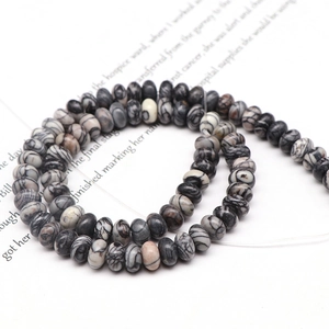 Macro shot of black and white striped flat natural stone beads for DIY jewelry making