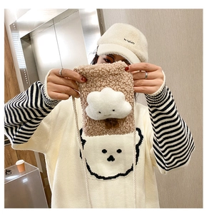 Detail of soft teddy plush cloud crossbody bag in beige showing size and texture