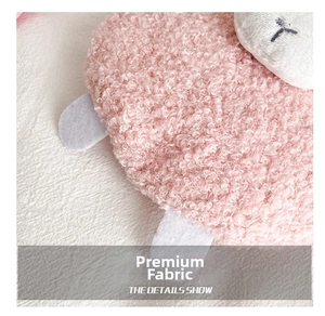 Detail showing the soft pink sherpa texture and white embroidery of the plush sheep bag