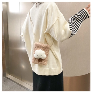 Detail of plush lamb wool crossbody bag in dusty rose featuring a white cloud 3D patch