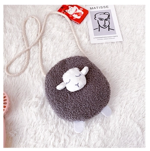 Detail of grey plush sheep crossbody bag with cute embroidery and woven strap