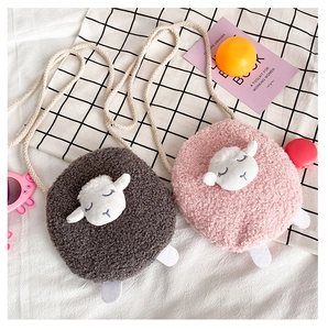 Detail of plush cartoon sheep bags with embroidery and woven shoulder straps in two colors