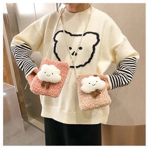 Detail of pink and beige plush fleece cloud shoulder bags with cute cartoon decorations
