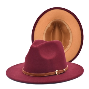 Detail of burgundy fedora with camel interior and brown leather band with gold buckle
