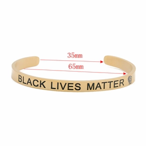 Detailed size view of gold stainless steel cuff featuring Black Lives Matter engraving