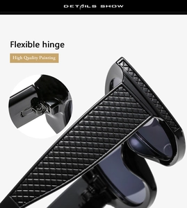 Close-up of black sunglasses with textured scale pattern temples and flexible hinges