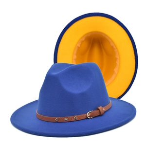 Detail view of royal blue fedora with yellow brim lining and brown leather studded band
