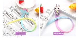 Detail of colorful unicorn and rainbow hair clips with gradient long hair extensions