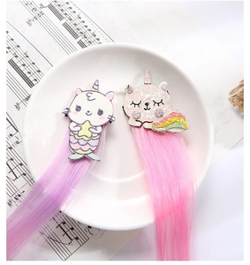Close-up of glitter unicorn and cat hair clips with 20cm pink and purple hair extensions