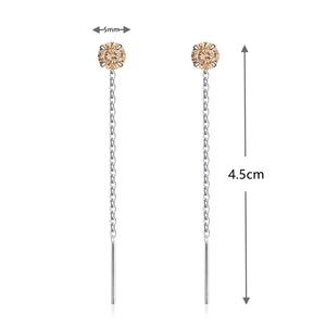 Detail of 4.5cm silver tassel earrings featuring 5mm champagne round-cut gemstones