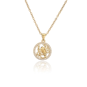 Detail of gold Scorpio pendant with relief carving and sparkling zircon border