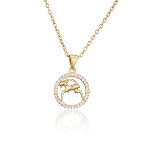 Macro view of gold Capricorn pendant with micro-paved zircons and leaping goat design