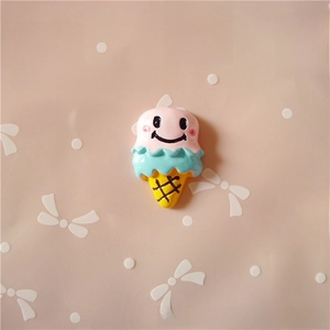 Detail of a cartoon resin ice cream charm with a pink smiley face for DIY hair accessories