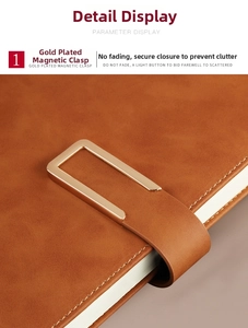 Detail of the brown leather notebook showing a polished gold magnetic buckle and stitching