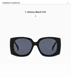 Detail of oversized square black sunglasses with glossy finish and C01 grey lenses
