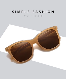 Close-up of amber fashion sunglasses with deep brown lenses showing the inner temple details