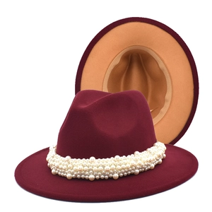 Detailed close-up of burgundy wool fedora featuring white pearl trim and contrast tan interior