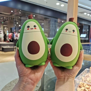 Close-up of cute avocado double-walled insulated glass cups held in hands