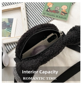 Detail view of the black plush shoulder bag's interior capacity for small items