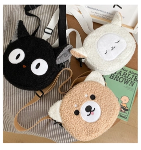 Cute animal plush round shoulder bags in cat and dog styles on a wooden desk setup