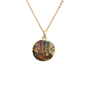 Gold necklace with circular pendant featuring colorful baguette stones and starburst design