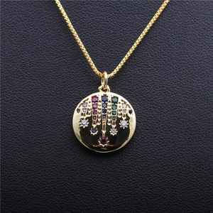 Golden round pendant necklace with colorful zircon star pattern on black leather