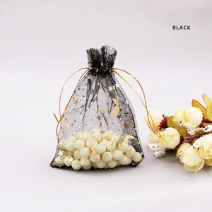 Black organza jewelry pouch with gold star moon prints and decorative pearls